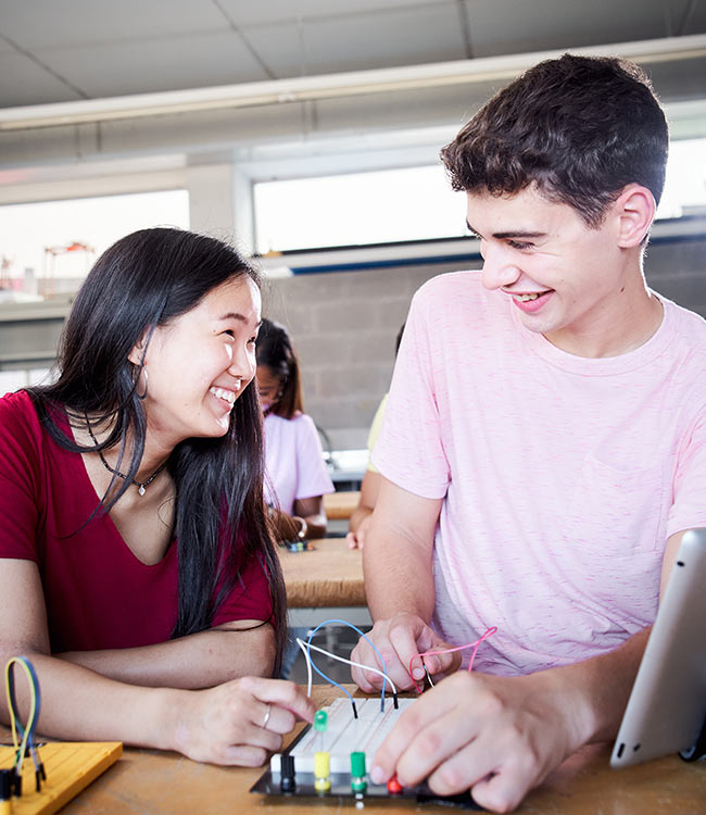 Two young students working with breadboard NZSE